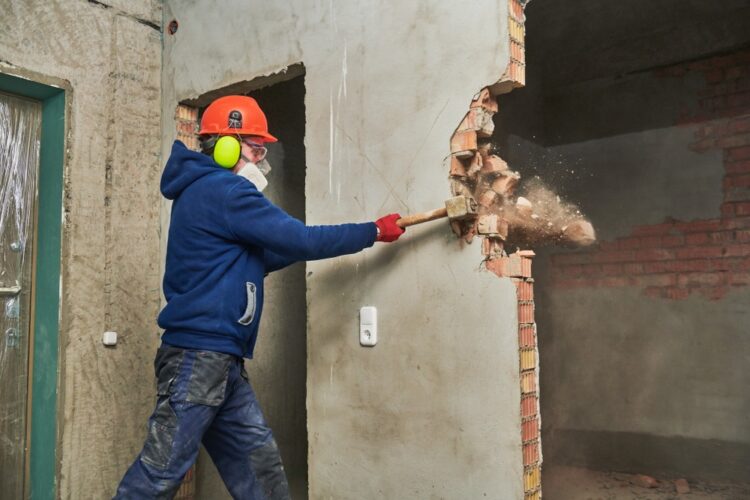 A man demolishing the interior of a house