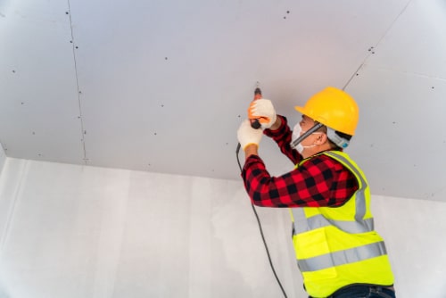 Man Installing Drywall For Enclosure Technique For Lead Paint Removal