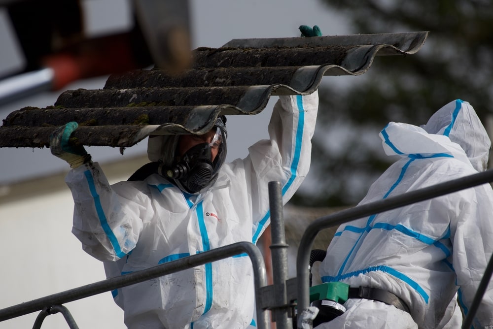 Asbestos Removal Expert wearing a Protective Suit and Mask.